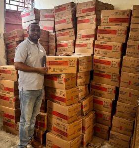 Lamp Manager Benoit Florestal with part of the UNICEF donation